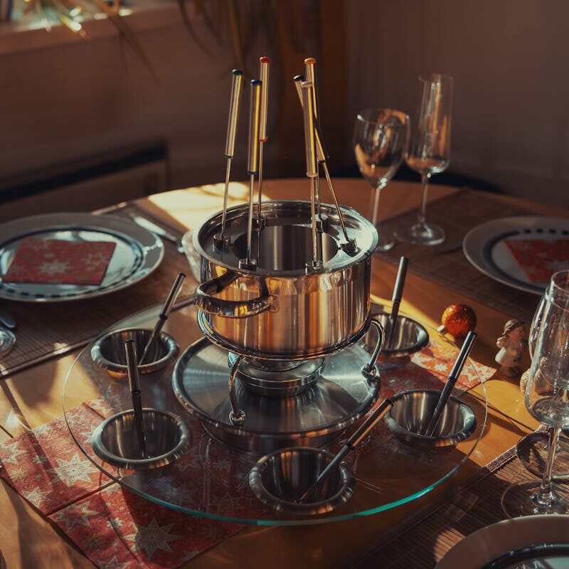 Empty Fondue Set, Plates and Glasses on a Table